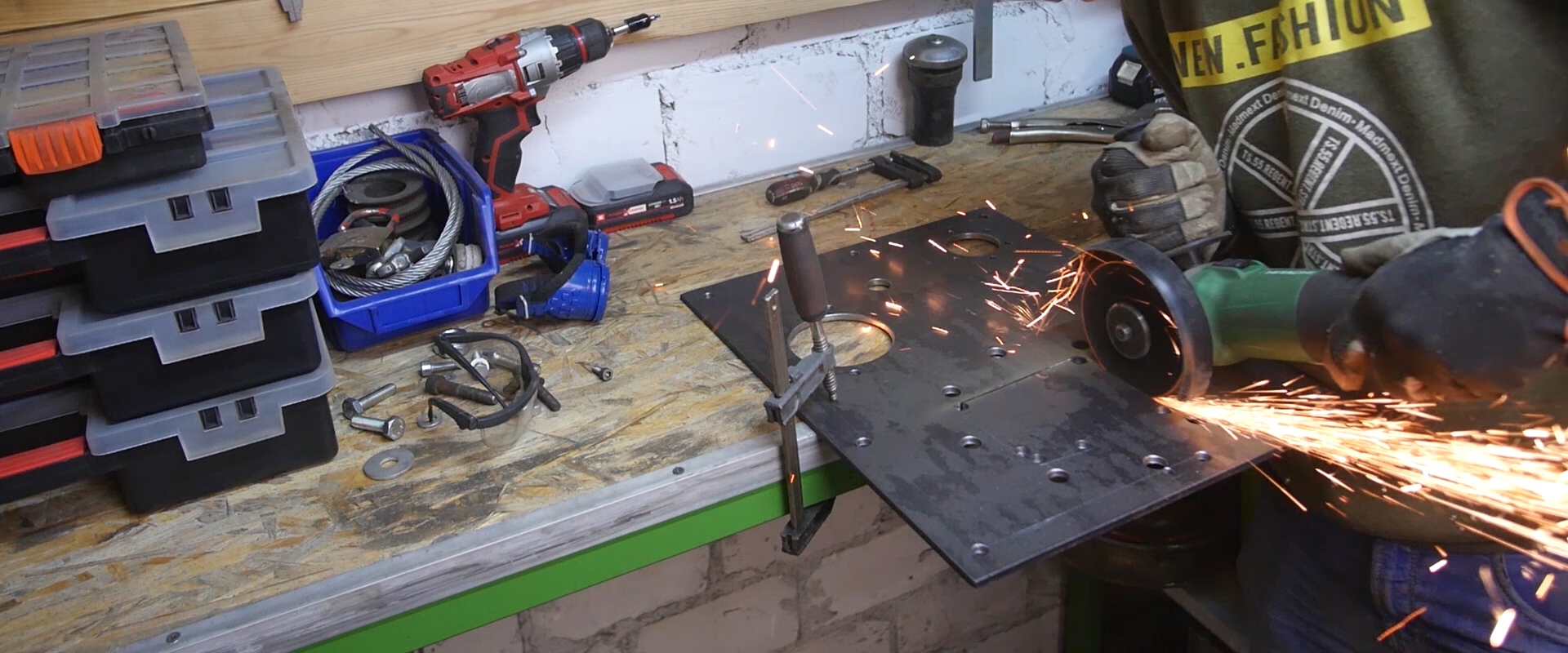 Sheet metal being cut with a grinder.